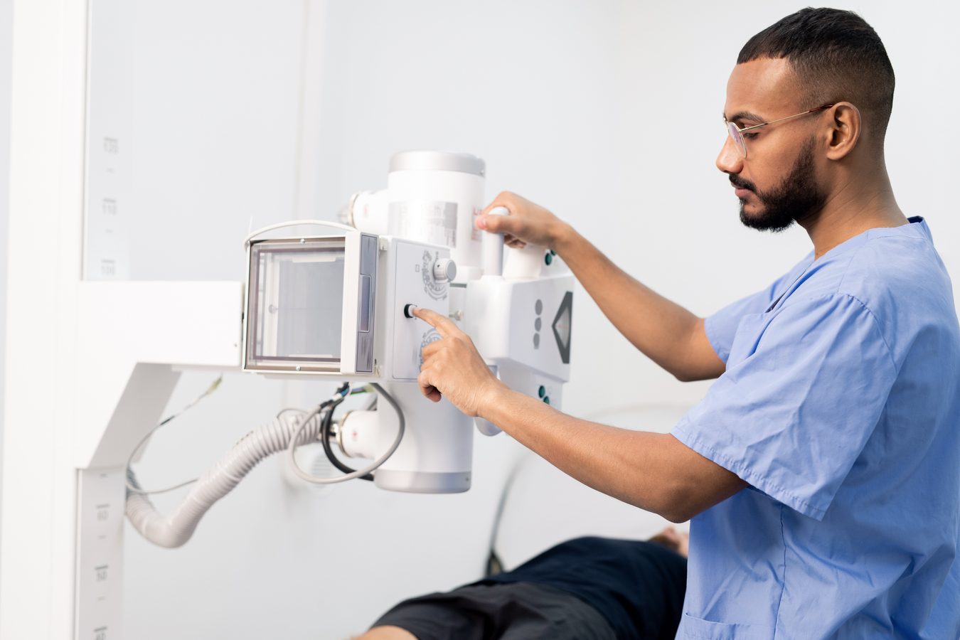 Radiologic technologist operating imaging equipment