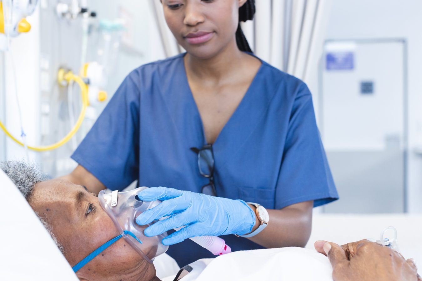 Respiratory therapist working with patient on breathing treatment